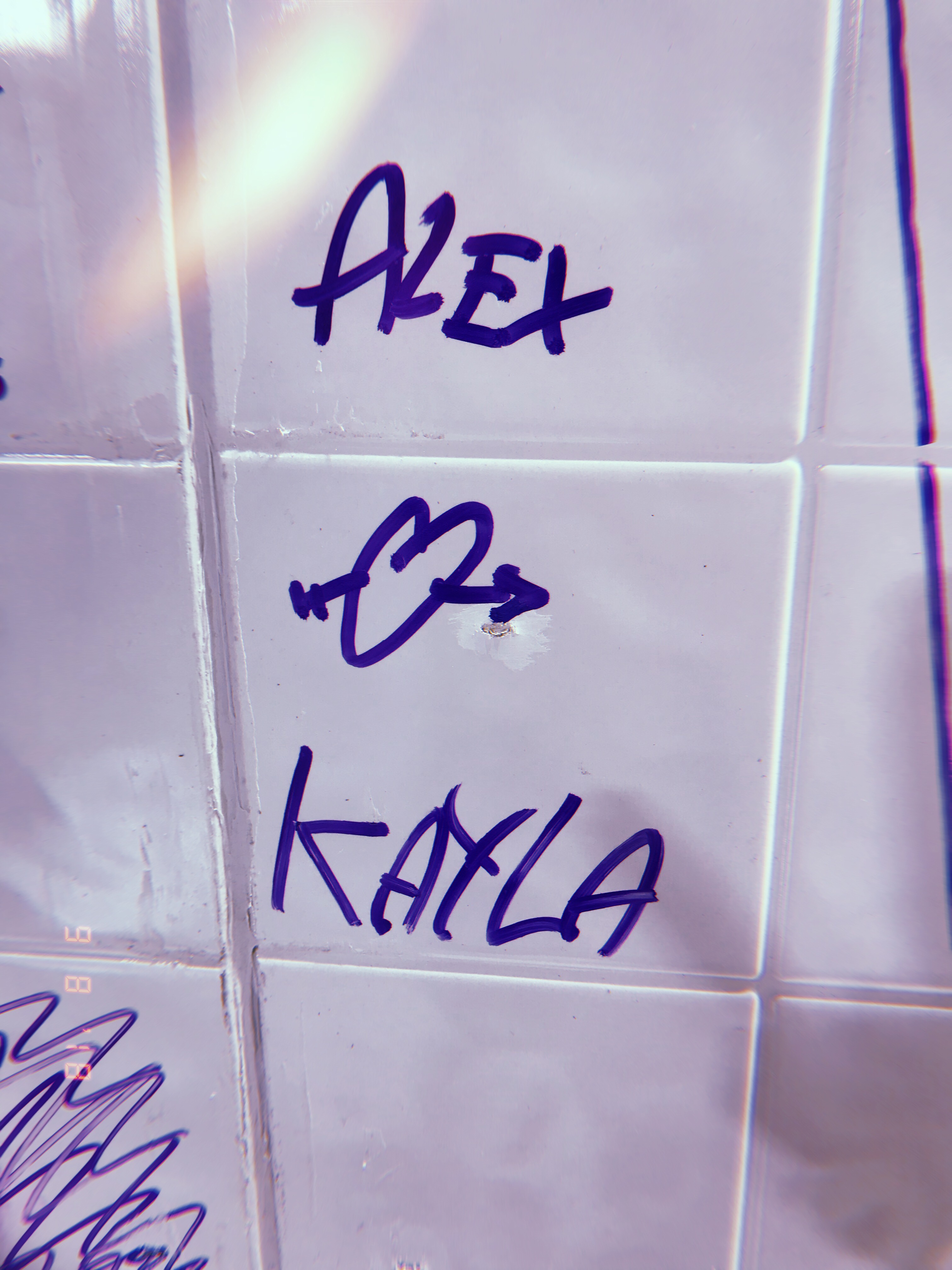 Alex and Kayla's names written on a tile wall in Chicago, September 2018