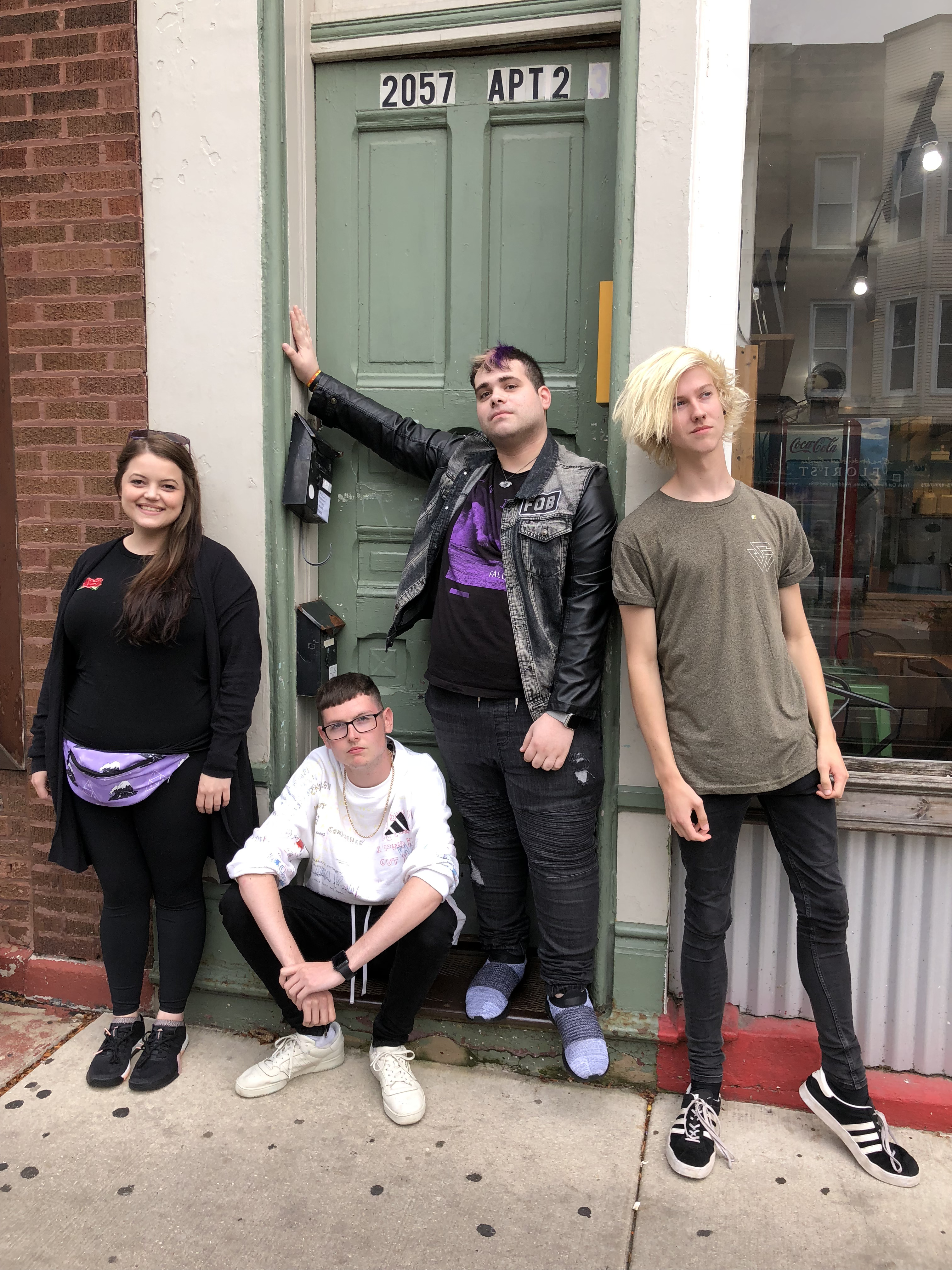Kayla, Alex, Ryan, and Euan outside the Take This to Your Grave apartment door, September 2018