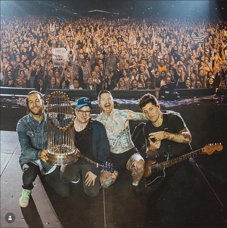 Fall Out Boy on stage at Wrigley Field with the Cubs World Series trophy, September 2018